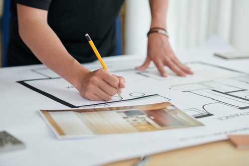 Closeup,Image,Of,Interior,Designer,Working,On,Apartment,Blueprint